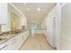 Bright kitchen with granite countertops, white cabinets, and tile flooring at 5372 Pamela Wood Way # 7, Sarasota, FL 34233
