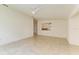 Bright living room with tile floors and a view of the kitchen at 5372 Pamela Wood Way # 7, Sarasota, FL 34233