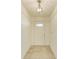 Clean entryway with tile floors and a light fixture at 5372 Pamela Wood Way # 7, Sarasota, FL 34233