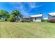 Home features a spacious backyard with lush grass and screened patio at 5372 Pamela Wood Way # 7, Sarasota, FL 34233