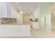 Kitchen with granite countertops, white cabinets, and breakfast bar at 5372 Pamela Wood Way # 7, Sarasota, FL 34233