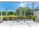 Relaxing screened patio with numerous plants and wind chimes at 5372 Pamela Wood Way # 7, Sarasota, FL 34233