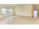 Bright and sunny living room with tile floors and window at 5372 Pamela Wood Way # 7, Sarasota, FL 34233
