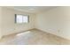 Bright bedroom with tile flooring and window with blinds at 5372 Pamela Wood Way # 7, Sarasota, FL 34233