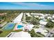 Aerial view of community with pool, tennis court, and numerous homes at 5372 Pamela Wood Way # 7, Sarasota, FL 34233