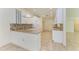 Kitchen boasts granite countertops, white cabinets, and tile floors at 5372 Pamela Wood Way # 7, Sarasota, FL 34233