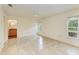 Main bedroom with tile floors and ensuite bathroom at 5372 Pamela Wood Way # 7, Sarasota, FL 34233
