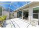 Spacious screened patio with tile flooring and various plants at 5372 Pamela Wood Way # 7, Sarasota, FL 34233