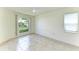 Spacious bedroom with tile floors and large window at 5372 Pamela Wood Way # 7, Sarasota, FL 34233