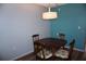 Small dining area with a wood table and four chairs at 305 30Th W Ave # A103, Bradenton, FL 34205