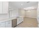 Modern kitchen with white cabinets, island, stainless steel appliances and dining area at 4769 Tortona Ct, Bradenton, FL 34211
