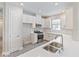 Clean and modern kitchen with white cabinets and stainless steel appliances at 4769 Tortona Ct, Bradenton, FL 34211