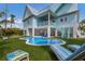 Private backyard with a freeform pool, putting green, and lounge chairs at 118 Mangrove Ave, Anna Maria, FL 34216