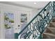 Elegant staircase with teal railing and etched glass doors at 118 Mangrove Ave, Anna Maria, FL 34216