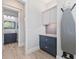 Laundry room with built-in cabinets and a half bathroom at 118 Mangrove Ave, Anna Maria, FL 34216