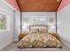 Bedroom with vaulted ceiling and tropical bedding at 118 Mangrove Ave, Anna Maria, FL 34216