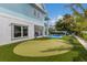 Private backyard with putting green and partially visible pool at 118 Mangrove Ave, Anna Maria, FL 34216