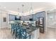 Modern kitchen with blue cabinets, granite countertops, and breakfast bar at 118 Mangrove Ave, Anna Maria, FL 34216