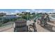 Relax and enjoy the view from this rooftop deck furnished with comfortable seating at 118 Mangrove Ave, Anna Maria, FL 34216