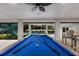 Game room with pool table, pool view, and stairs to upper level at 118 Mangrove Ave, Anna Maria, FL 34216