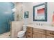 Bathroom with blue glass tile shower and granite vanity at 118 Mangrove Ave, Anna Maria, FL 34216