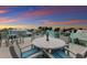 Rooftop deck with seating area and sunset view at 118 Mangrove Ave, Anna Maria, FL 34216