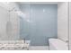 Bathroom with a freestanding tub and blue tile shower surround at 118 Mangrove Ave, Anna Maria, FL 34216