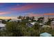 Aerial view of neighborhood with sunset in the background at 118 Mangrove Ave, Anna Maria, FL 34216