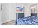 Bedroom with dresser, TV, and en-suite bathroom at 118 Mangrove Ave, Anna Maria, FL 34216