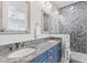 Bathroom with granite countertop, double sinks, and a walk-in shower at 118 Mangrove Ave, Anna Maria, FL 34216