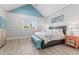 Bright bedroom with a large bed, coastal decor, and light wood floors at 118 Mangrove Ave, Anna Maria, FL 34216