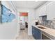 Wet bar with blue cabinets, granite countertop and mosaic tile backsplash at 118 Mangrove Ave, Anna Maria, FL 34216