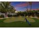 Landscaped backyard putting green with golf clubs at 118 Mangrove Ave, Anna Maria, FL 34216