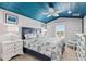 Bedroom with blue ceiling, window seat and coastal bedding at 118 Mangrove Ave, Anna Maria, FL 34216