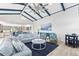 Living room with vaulted ceilings, coastal decor, and a large sectional sofa at 118 Mangrove Ave, Anna Maria, FL 34216