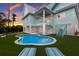 Resort-style backyard with a freeform pool and spacious patio at 118 Mangrove Ave, Anna Maria, FL 34216