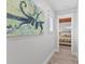 Hallway with coastal-themed artwork leading to a bedroom at 118 Mangrove Ave, Anna Maria, FL 34216