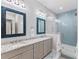 Bathroom boasts double sinks, a large shower, and blue tile at 118 Mangrove Ave, Anna Maria, FL 34216