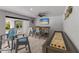 Bar area with seating, shuffleboard, and TV at 118 Mangrove Ave, Anna Maria, FL 34216