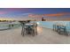 Rooftop deck with table and chairs, offering a relaxing space at 118 Mangrove Ave, Anna Maria, FL 34216