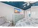 Bedroom with blue ceiling, dresser, and coastal-themed decor at 118 Mangrove Ave, Anna Maria, FL 34216