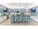 Open concept kitchen with blue cabinets and granite island at 118 Mangrove Ave, Anna Maria, FL 34216