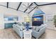 Living room with vaulted ceilings, coastal decor, and a large sectional sofa at 118 Mangrove Ave, Anna Maria, FL 34216