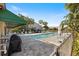 Community pool area with grill and lounge chairs at 3484 Beekman Pl # 15, Sarasota, FL 34235