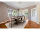 Formal dining room featuring hardwood floors and a decorative wallpaper at 7754 Westmoreland Dr, Sarasota, FL 34243