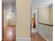 Upper hallway with hardwood floors and bathroom at 7754 Westmoreland Dr, Sarasota, FL 34243