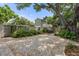 Large backyard with brick pavers and mature trees at 7754 Westmoreland Dr, Sarasota, FL 34243
