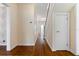 Long hallway with hardwood floors and staircase at 7754 Westmoreland Dr, Sarasota, FL 34243