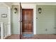 Ornate wooden front door with a screen door and welcome mat at 7754 Westmoreland Dr, Sarasota, FL 34243