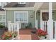 Front porch with white railings, brick flooring, and potted plants at 7754 Westmoreland Dr, Sarasota, FL 34243